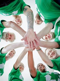 People joining hands together and smiling