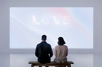 Couple with projector wall mockup psd rear view