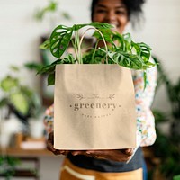 Shopping bag mockup psd with plant inside eco-friendly shop