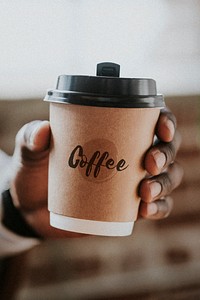 Man holding a takeaway coffee cup