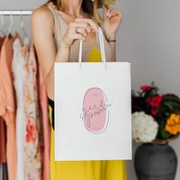 Woman carrying a shopping paper bag mockup