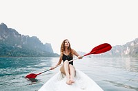 Woman paddling a canoe through a national park image element 