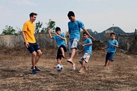 A U.S. Sailor, left, competes in a soccer match against Vietnamese students at the Da Nang Red Cross Association Vocational Center in Da Nang, Vietnam, April 7, 2014, during a community relations event in support of Vietnam Naval Exchange Activities (NEA) 2014.