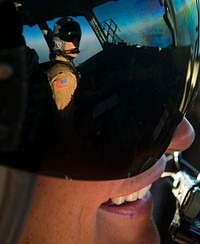 U.S. Air Force Capt. Erica Stooksbury, a C-17 Globemaster III aircraft pilot with the 816th Expeditionary Airlift Squadron, talks with her co-pilot, 1st Lt. Mark Benischek, during a humanitarian airdrop mission over Iraq Aug. 9, 2014.