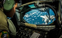 U.S. Air Force Senior Airman Crystal Cash, a boom operator with the 91st Air Refueling Squadron, refuels an F-15 Eagle aircraft attached to the 125th Fighter Wing during Vigilant Shield 15 over the United States Oct. 20, 2014.