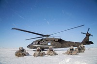 U.S. Army paratroopers with the 6th Engineer Battalion, 2nd Engineer Brigade pull security after exiting a UH-60 Black Hawk helicopter during exercise Arctic Pegasus near Deadhorse, Alaska, May 2, 2014.
