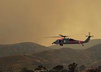 A U.S. Navy MH-60S Seahawk helicopter assigned to Helicopter Sea Combat Squadron (HSC) 3 takes off from Marine Corps Base Camp Pendleton, Calif., May 15, 2014, to help fight fires in the region.