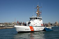 The crew of the coastal patrol boat USCGC Haddock (WPB 87347) tows a seized panga boat into San Diego Bay Oct. 2, 2014.