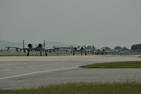 Four U.S. Air Force A-10 Thunderbolt II aircraft assigned to the 25th Fighter Squadron taxi down the runway at Osan Air Base in South Korea during a mass launch as part of the Beverly Midnight 14-4 Sept. 17, 2014.