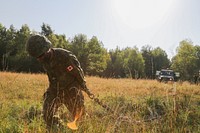 Canadian Army Master Cpl. Nicolas Pelletiec of the 3rd Battalion, Royal 22nd Regiment, 5th Canadian Mechanized Brigade Group drags a chain while conducting vehicle recovery operations during exercise Allied Spirit II at the U.S. Army’s Joint Multinational Readiness Center in Hohenfels, Germany, Aug. 9, 2015.