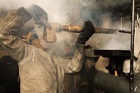151020-N-KW492-054 MEDITERRANEAN SEA (Oct. 20, 2015) Machinist's Mate 3rd Class Thomas Carroll, from Queens, N.Y., removes a burner barrel from a boiler aboard the amphibious assault ship USS Kearsarge (LHD 3) Oct. 20, 2015.
