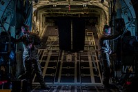 Two Airmen, assigned to the 71st Rescue Squadron at Moody Air Force Base, Ga., look out the windows of a C-130J Hercules during rescue and refueling training near Beja Air Base, Portugal, Oct. 23, 2015.
