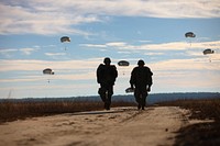 U.S. paratroopers return after completing their jumps in participation for the 18th Annual Randy Oler Memorial Operation Toy Drop, hosted by U.S. Army Civil Affairs & Psychological Operations Command (Airborne), Dec. 4, 2015, at Fort Bragg, N.C. Operation Toy Drop is one of the world’s largest combined airborne operations and allows soldiers the opportunity to help children in need receive toys for the holidays.