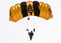 A U.S. Army Special Operations Forces parachute team member descends toward Luzon Drop Zone during the 18th Annual Randy Oler Memorial Operation Toy Drop, hosted by U.S. Army Civil Affairs & Psychological Operations Command (Airborne) at Camp Mackall, N.C., Dec. 7, 2015.