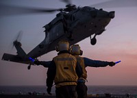 PACIFIC OCEAN (Feb. 13, 2016) Aviation Boatswain&rsquo;s Mate (Handling) Airman Justin Easley oversees Aviation Boatswain&rsquo;s Mate (Handling) Airman Olen Harris as he signals an MH-60S Sea Hawk helicopter, attached to the &ldquo;Wildcards&rdquo; of Helicopter Sea Combat (HSC) Squadron 23, as it prepares to land on the flight deck of amphibious assault ship USS Boxer (LHD 4).