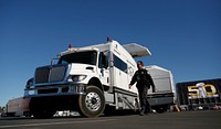 A U.S. Customs and Border Protection non-intrusive inspection vehicle waits on the parking lot to begin scanning a line of trucks in advance of Super Bowl 50 in Santa Clara, Calif., 2016.