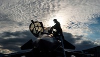 A French air force fighter pilot climbs out of a Dassault Rafale, a multirole fighter aircraft after participating in a joint terminal attack controller training scenario during exercise SERPENTEX 16, in Corsica, France, March 10, 2016.