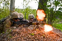 U.S. Army Spc. Lucas Johnson, left, an infantryman with Eagle Troop, 2nd Squadron, 2nd Cavalry Regiment, stationed at Vilseck, Germany, suppresses a simulated enemy with an M240B machine gun during Exercise Spring Storm in Voru, Estonia, May 14, 2016.