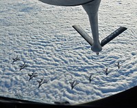 Four U.S. Air Force F-16C Fighting Falcons and four Swedish Air Force JAS 39 Gripens fly in formation together behind a U.S. Air Force KC-135 Stratotanker during aerial refueling training in Swedish airspace, Feb. 8, 2018.