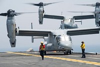 A U.S. Marine Corps MV-22 Osprey tiltrotor aircraft, attached to the 13th Marine Expeditionary Unit (MEU), prepares to land behind another MV-22 on the flight deck of the amphibious assault ship USS Boxer (LHD 4) in the Arabian Gulf July 6, 2016.