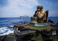 Cpl. Ryan Dills communicates with other assault amphibious vehicles while traveling from amphibious assault ship USS San Diego to Royal Australian Navy Canberra class amphibious ship HMAS Canberra (L02) in the Pacific Ocean, July, 18 2016.