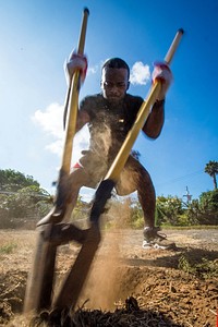 U.S. Navy Sonar Technician (Surface) 3rd Class Cedric Nixon, a Chicago native assigned to the pre-commisioning unit guided-missile destroyer USS John Finn (DDG 113) digs a hole for a fence post while volunteering at a Habitat for Humanity event, during San Diego Fleet Week 2016 in San Diego, Sept. 14, 2016.