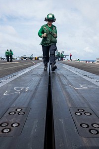 U.S. Navy Aviation Boatswain's Mate (Equipment) 3rd Class Hailey Barela, from Rio Rancho, New Mexico, inspects a catapult track prior to flight operations on the flight deck of the Navy’s forward-deployed aircraft carrier USS Ronald Reagan (CVN 76) during Valiant Shield 2018 in the Philippine Sea Sept. 18, 2018.