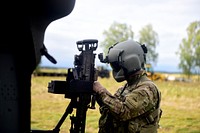 The door gunner of a UH-60 Black Hawk, from the 3rd Battalion, 501st Aviation Regiment, Combat Aviation Brigade, 1st Armored Division stationed at Fort Bliss, Texas prepares his M240B for a live fire exercise that took place at Pabrade, Lithuania, Aug. 30, 2016.