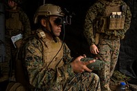 Lance Cpl. Jorge Brito uses the Augmented Immersive Team Trainer to call in mortar fire on virtual targets at Camp Lejeune, N.C., Dec. 13, 2016.