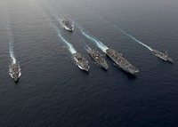 Clockwise from left, the guided-missile destroyer USS Spruance (DDG 111), the Military Sealift Command (MSC) ammunition and cargo ship USNS Washington Chambers (T-AKE 11), the guided-missile destroyer USS Decatur (DDG 73), the amphibious assault ship USS Bonhomme Richard (LHD 6), the Military Sealift Command (MSC) fleet oiler USNS Walter S. Diehl (T-AO 193) and the amphibious dock landing ship USS Germantown (LSD 42) steam in formation as part of interoperability drills between the Pacific Surface Action Group (PAC SAG) and Bonhomme Richard Expeditionary Strike Group (BHR ESG) in the South China Sea Sea, Oct. 13, 2016.