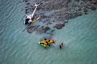 A U.S. Marine Corps CH-53E Super Stallion with Marine Heavy Helicopter Squadron 463, Marine Aircraft Group 24, provides on- scene awareness for a downed civilian helicopter that made an emergency landing on a sandbar in Kaneohe Bay, Hawaii, Oct. 22, 2018.