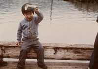 Eskimo boy catching his first fish using can, line, & lure. Original public domain image from Flickr