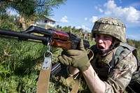 A Ukrainian soldier with the 1st Airmobile Battalion, 79th Air Assault Brigade calls out to a fellow soldier, letting the other soldier know he is set and ready to cover his movement during pairs movement training at the Yavoriv Combat Training Center on the International Peacekeeping and Security Center, near Yavoriv, Ukraine, May 15, 2017.