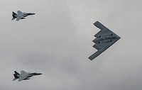 A U.S. Air Force B-2 Stealth Bomber and two F-15 Strike Eagle aircraft fly past spectators during the 2017 Royal International Air Tattoo (RIAT) located at RAF Fairford, United Kingdom, on July 16, 2017.