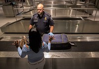 Officers with the U.S. Customs and Border Protection, Office of Field Operations, process international arrivals of passenger flights at Boston Logan International Airport June 21, 2017 in Boston, Mass. U.S. Customs and Border Protection photo by Glenn Fawcett.