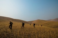 U.S. Air Force Reserve Officer Training Corps Cadets walk towards their designated location at Yakima Training Center in Yakima, Wash., Aug. 5, 2017 as part of Exercise Mobility Guardian 2017.