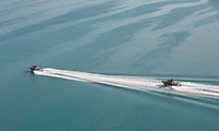 Two U.S. Coast Guard vessels patrol in tandem as they cruise over now calm, but murky, waters of the Florida Keys after Hurricane Irma September 12, 2017.