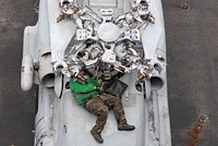 U.S. Navy Aviation Machinist's Mate Airman Felix Carcamo replaces the droop stop heating element on an SH-60F Seahawk helicopter from Helicopter Anti-Submarine Squadron 4 on the flight deck of the aircraft carrier USS Ronald Reagan (CVN 76) July 20, 2009, while under way in the Gulf of Oman. (DoD photo by Mass Communication Specialist Seaman Oliver Cole, U.S. Navy/Released). Original public domain image from Flickr