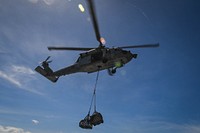 An MH-60S Sea Hawk helicopter, assigned to the "Sea Knights" of Helicopter Sea Combat Squadron (HSC) 22, delivers pallets to the Military Sealift Command hospital ship USNS Comfort (T-AH 20) during a replenishment at sea with the dry cargo and ammunition ship USNS Robert E. Peary (T-AKE 5) in the Caribbean Sea Nov. 15, 2017.
