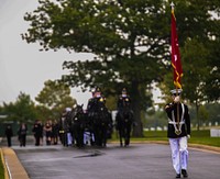 A Marine carries a general officer flag during the procession for a full honors funeral at Arlington National Cemetery, Arlington, Va., Sept. 13, 2017.