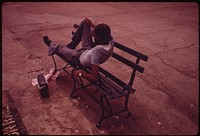 Man Lounging on a Park Bench with His Radio on the Reis Park Boardwalk in New York City. The Inner City Today Is an Absolute Contradiction to the Main Stream America of Gas Stations Expressways, Shopping Centers and Tract Homes.