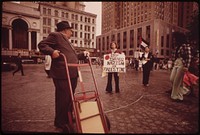 Fountain Square in Downtown Cincinnati Is a Public Square That Works for the City and Its People in a Myriad of Ways: Delivery Man Pauses to Read Signs of Pro-Arab Pickets 05/1973. Photographer: Hubbard, Tom. Original public domain image from Flickr