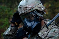 A U.S. Soldier assigned to the 615th Military Police Company, 709th Military Police Battalion, 18th Military Police Brigade puts on a gas mask during an Urban Operations training at the 7th Army Training Command’s Grafenwoehr Training Area, Germany, Oct. 20, 2017.