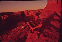 Backpackers Terry Mcgaw and Glen Denny Rest in the Setting Sun at the End of the Trail to Delicate Arch, 05/1972. Original public domain image from Flickr