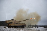 A U.S. Army M109A6 Paladin howitzer, assigned to Bravo Battery, 1st Battalion, 82nd Field Artillery Regiment, 1st Armored Brigade Combat Team, 1st Cavalry Division, fires its main gun at a range during Table Six qualifications at U.S. Army Garrison Bavaria in Grafenwoehr, Germany, Jan. 9, 2019.