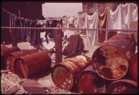 Rusty Oil Cans Pile Up near Home in Broad Channel, a Jamaica Bay Community with Numerous Pollution Problems 05/1973. Photographer: Tress, Arthur. Original public domain image from Flickr
