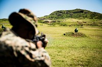 U.S. Marine Corps Sgt. Tyrell Bennet, an assaultman with Fox Company, 2nd Battalion, 3d Marine Regiment, engages targets using sponge grenades during a non-lethal weapons fire familiarization and demonstration at the Ulupau Range Training Facility, Marine Corps Base Hawaii, March 28, 2018.