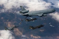 A pair of U.S Air Force F-35 Lightning II aircraft with the 419th Fighter Squadron fly alongside a KC-10 Extender crewed by Reserve Citizen Airmen with the 78th Air Refueling Squadron, 514th Air Mobility Wing, as an F-15 Eagle with the 104th Fighter Squadron approaches during a joint training mission over the United States, April 7, 2018.