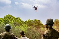 U.S. Airmen assigned to the 130th Operations Group look on as an Army UH-60 Black Hawk assigned to Charlie Company, 2nd General Support Aviation Battalion, 104th Aviation Regiment prepares to land as they perform Survival, Evasion, Resistance and Escape (SERE) training June 2, 2018, at Alum Creek, W.Va. The Airmen completed a refresher version of the original SERE course, which is required every three years, to ensure that in case of emergency that they would have the competency to survive in numerous hostile conditions.