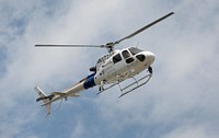 A U.S. Customs and Border Protection AS350 A-Star helicopter flies over during a funeral service held for U.S. Customs and Border Protection Office of Intelligence Collection Operations Manager Christopher T. Bacon in Grand Forks, North Dakota, June 14, 2018, Bacon was involved in a fatal car accident near Crookston, Minn., June 7, 2018.
